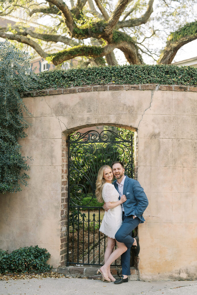 couple smilig and hugging during engagement session in Charleston