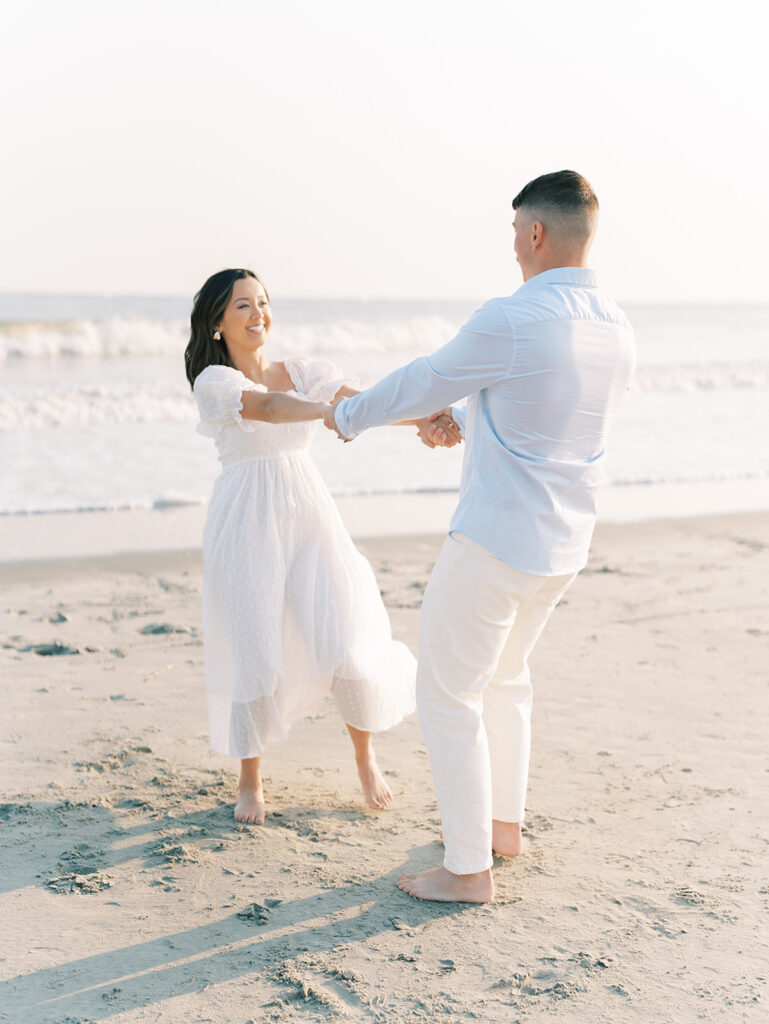 Couple twirling during engagement session at Isle of Palm, Isle of Palm engagement session location